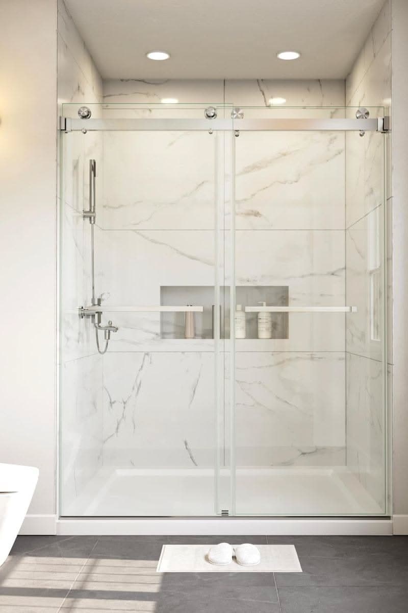 Bright walk-in shower with marble-look wall tile and glass enclosure
