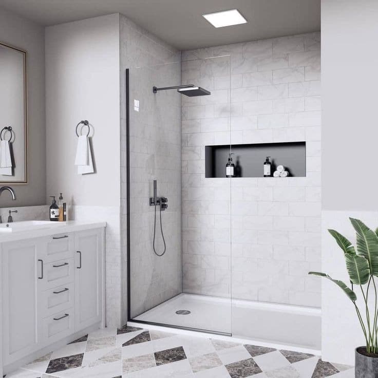 Bright bathroom with patterned floor, vanity, and tiled shower