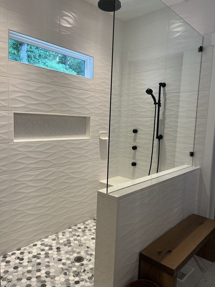 Custom tile shower with wave-pattern wall tile, niche, window, and bench