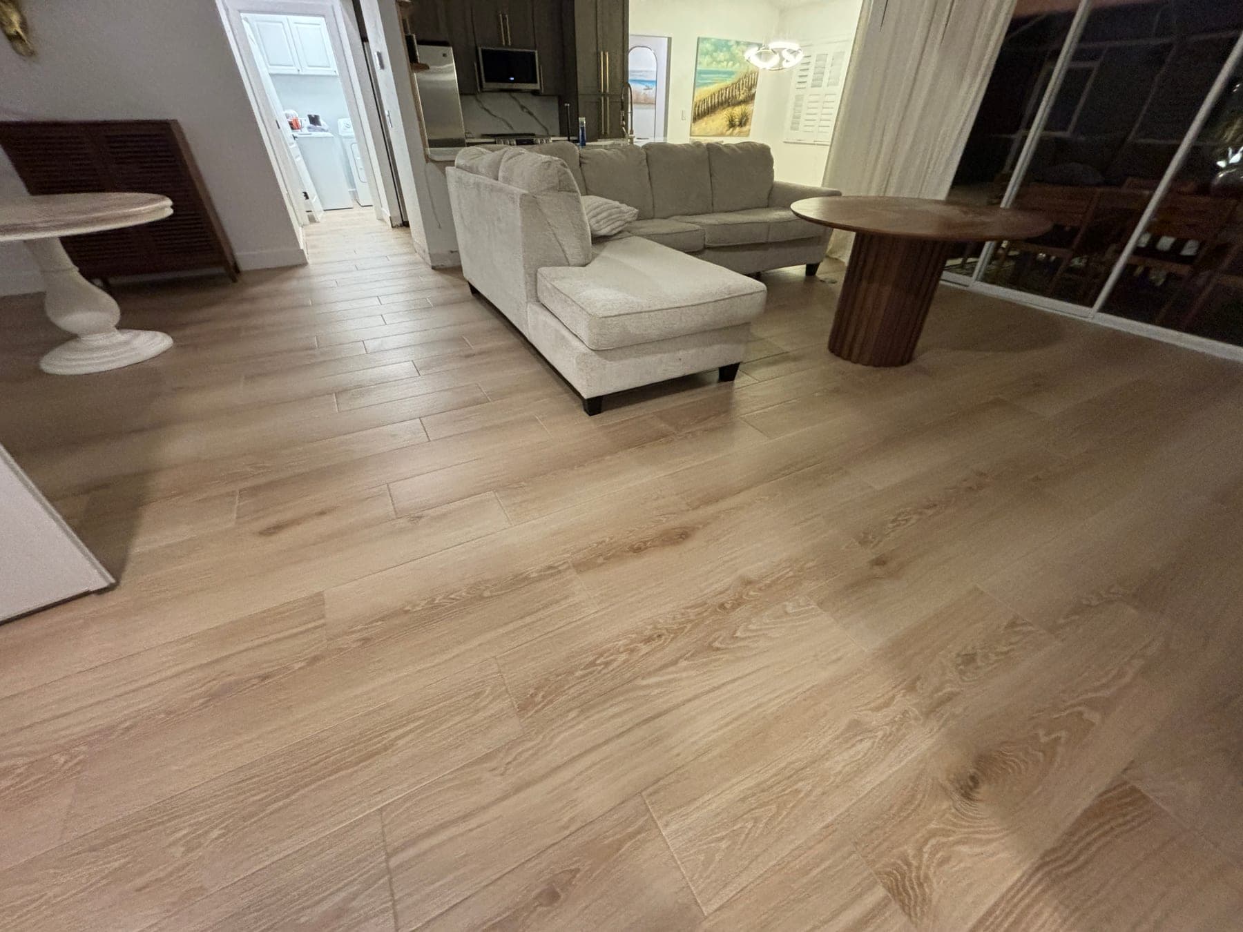 Wood-look floor tile extending through a connected living and dining area