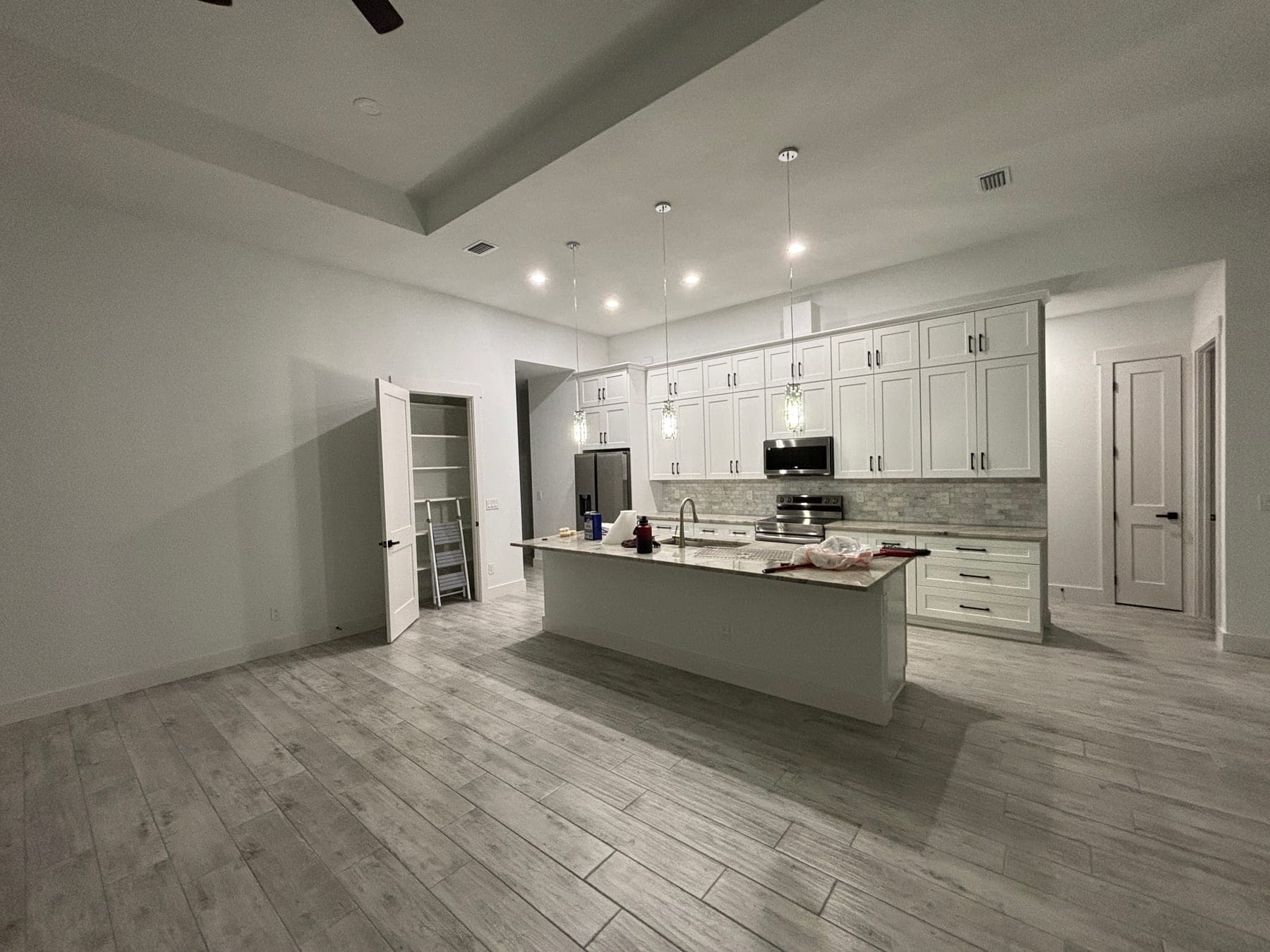 Gray wood-look tile floor in a bright open kitchen
